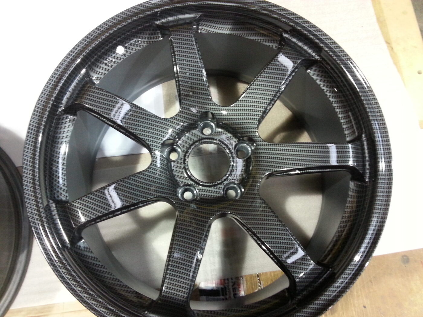 Car alloy wheels coated in carbon fibre hydrographic film painted grey