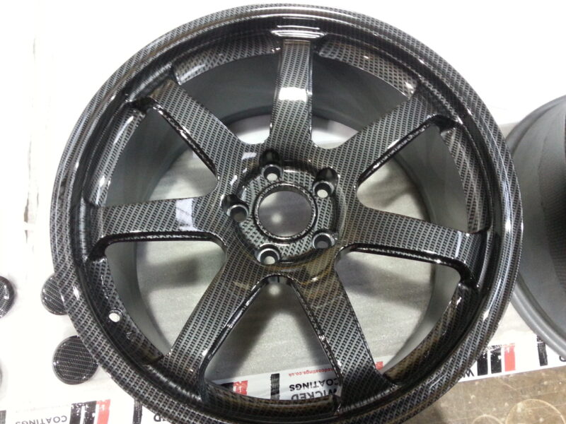 Car alloy wheels coated in carbon fibre hydrographic film painted grey