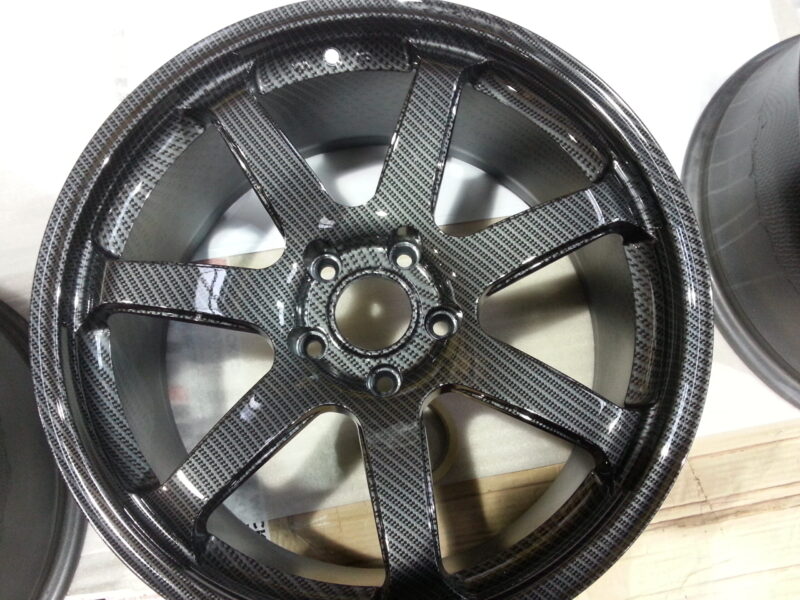 Car alloy wheels coated in carbon fibre hydrographic film painted grey