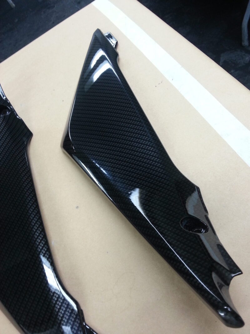 Motorbike parts coated in carbon fibre hydrographic film painted black