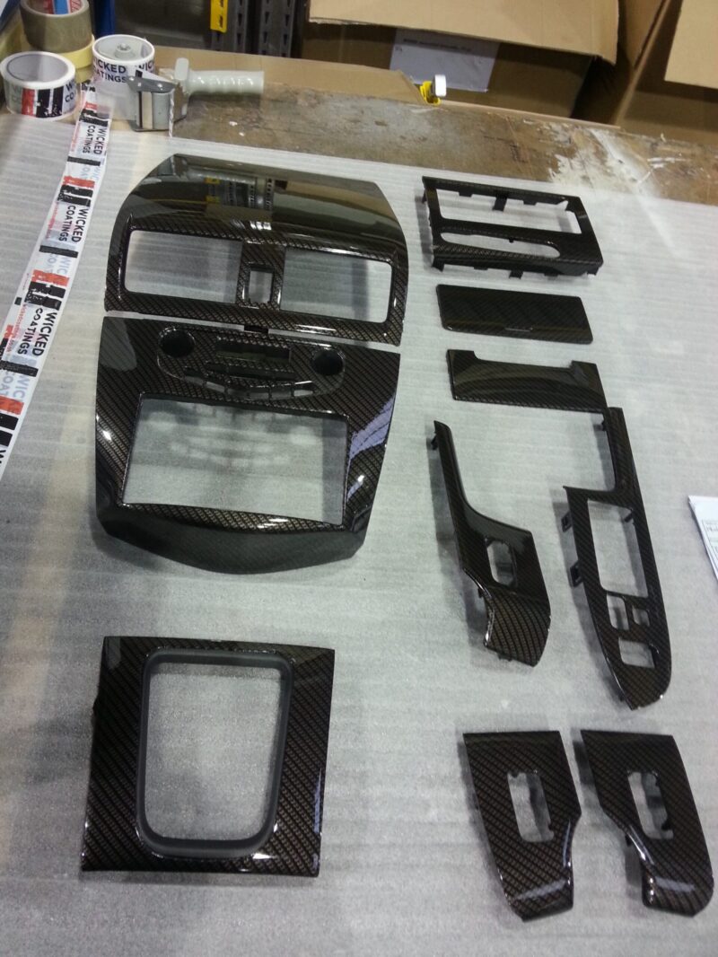 Car interior various elements coated in carbon fibre hydrographic film painted black