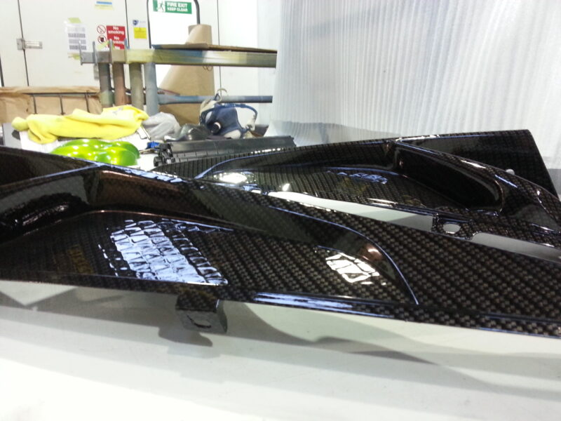 Motorbike parts coated in carbon fibre hydrographic film painted black