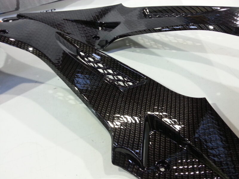 Motorbike parts coated in carbon fibre hydrographic film painted black