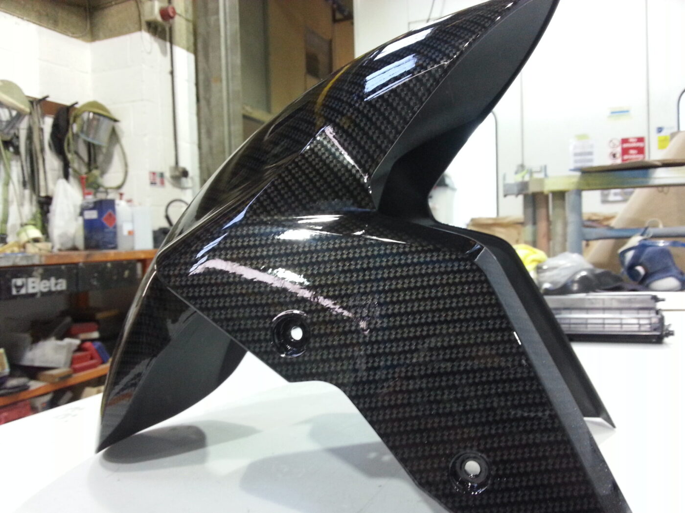Motorbike parts coated in carbon fibre hydrographic film painted black
