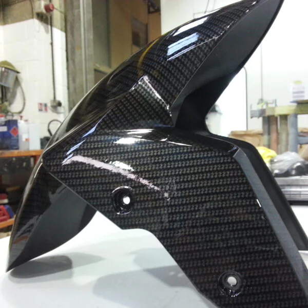 Motorbike parts coated in carbon fibre hydrographic film painted black