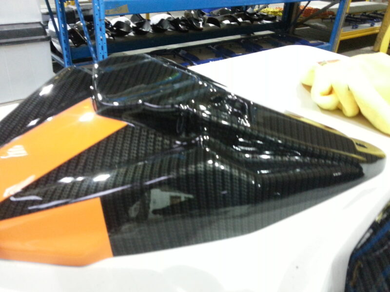 Motorbike parts coated in carbon fibre hydrographic film painted black and orange