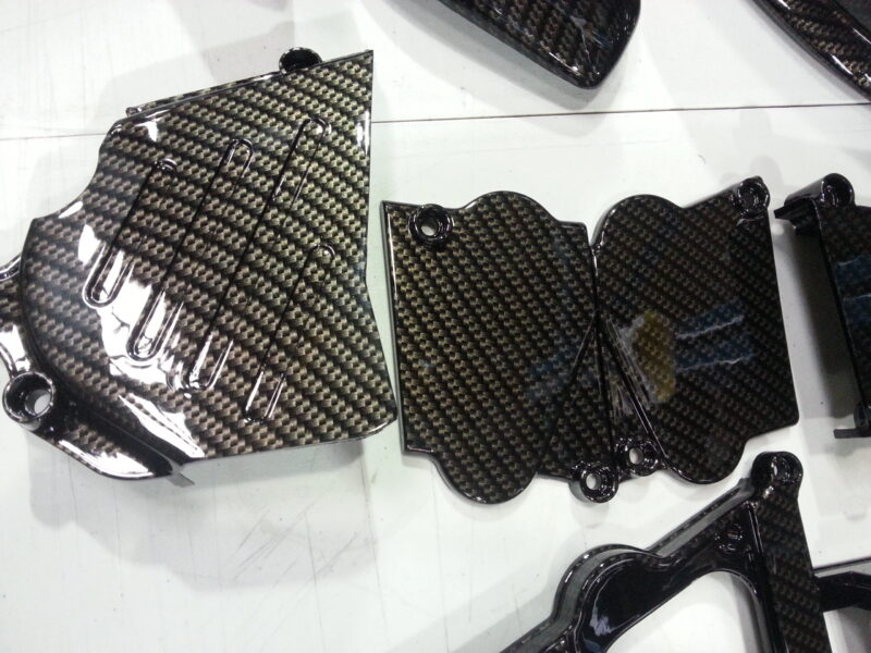 Motorbike parts coated in carbon fibre hydrographic film painted black