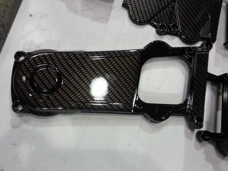 Motorbike parts coated in carbon fibre hydrographic film painted black