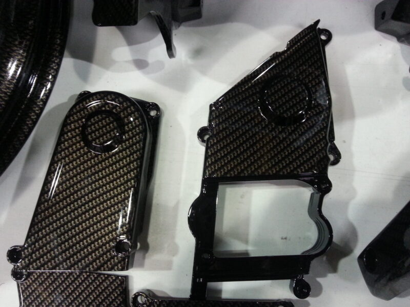 Motorbike parts coated in carbon fibre hydrographic film painted black