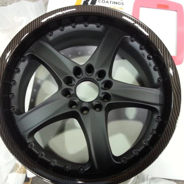 Car alloy wheels coated in carbon fibre hydrographic film painted black