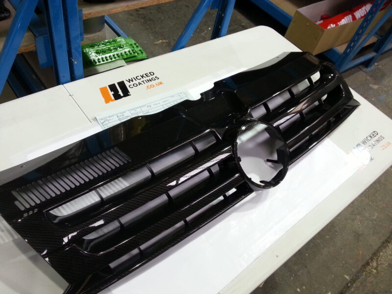 VW radiator grill coated in carbon fibre hydrographic film painted black