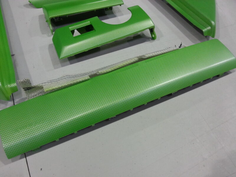 Car interior elements coated in carbon fibre painted green