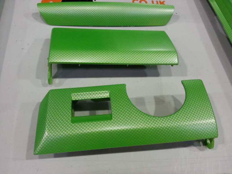 Car interior elements coated in carbon fibre painted green