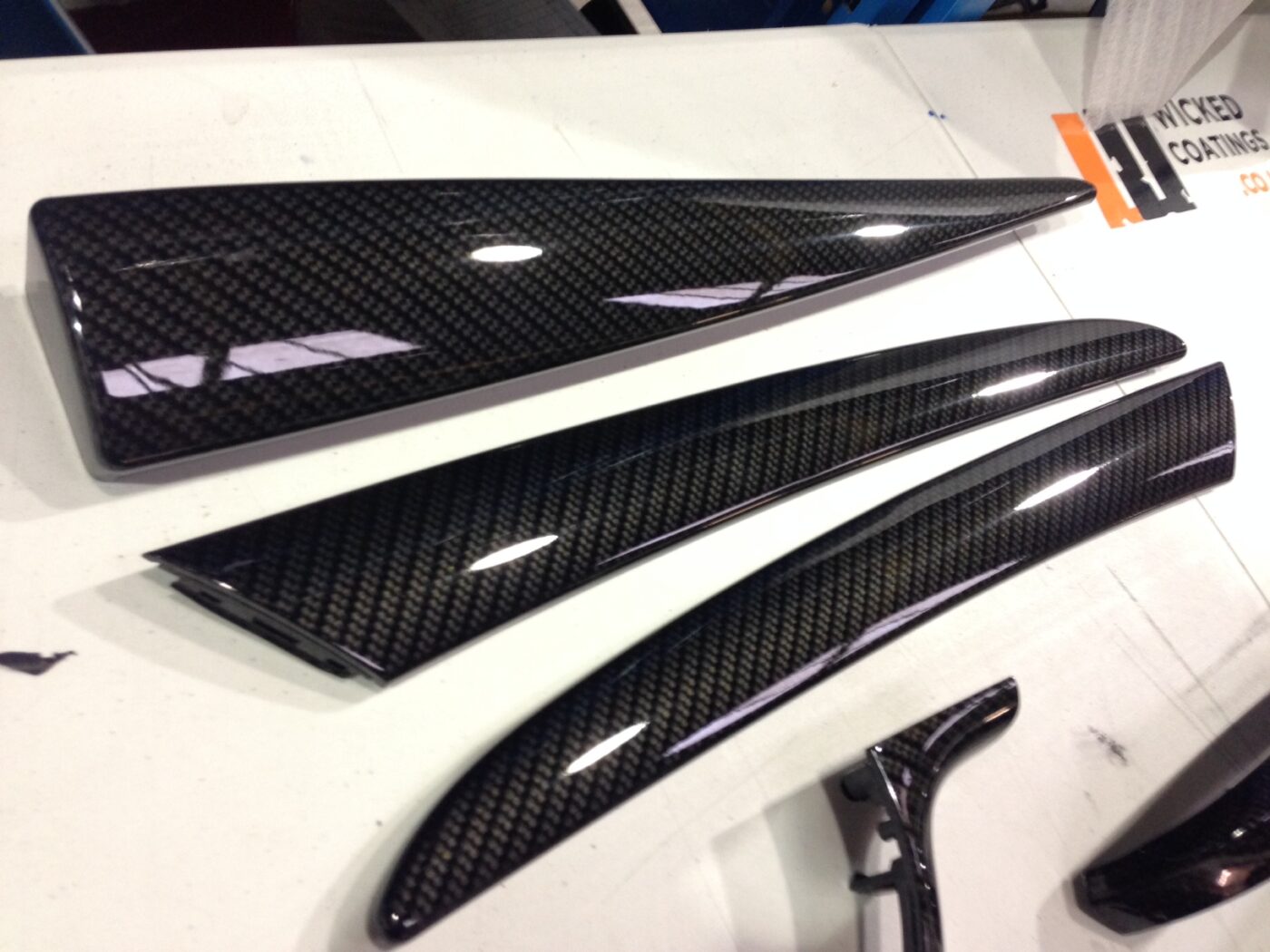 Various car interior parts coated in carbon fibre