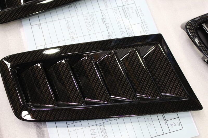 Car exterior element coated in carbon fibre hydrographic film painted black