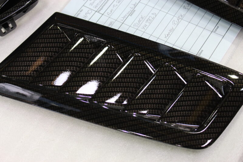 Car exterior element coated in carbon fibre hydrographic film painted black
