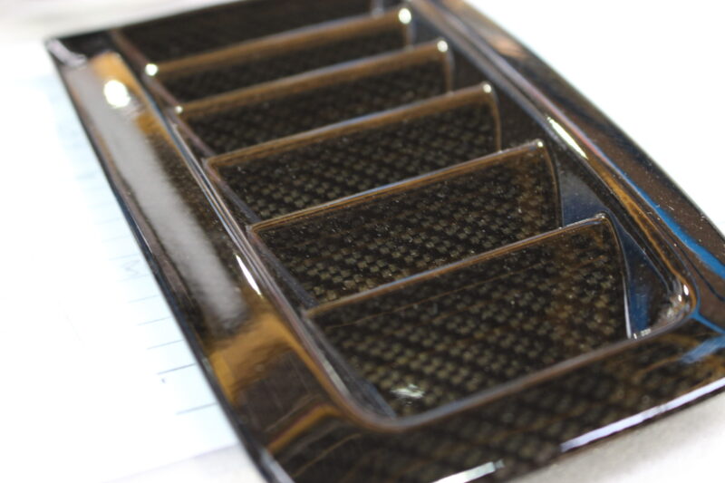 Car exterior element coated in carbon fibre hydrographic film painted black