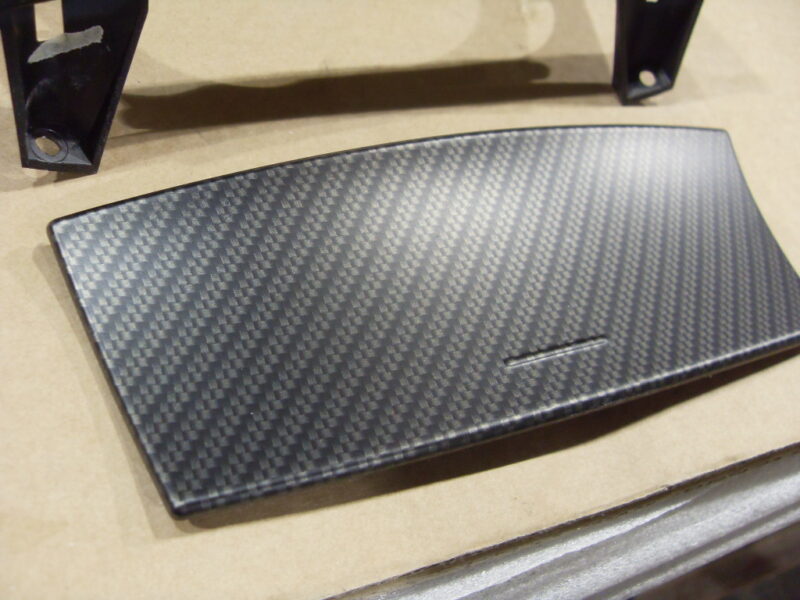 Car dashboard elements coated in carbon fibre hydrographic film painted black