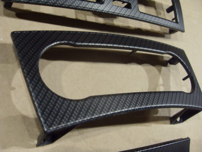 Car dashboard elements coated in carbon fibre hydrographic film painted black