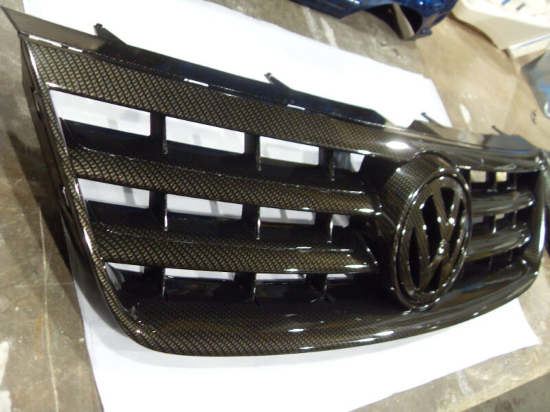 VW radiator cover coated in carbon fibre hydrographic film painted black