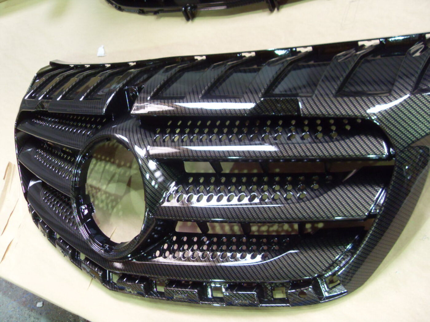Mercedes radiator cover coated in carbon fibre hydrographic film painted black