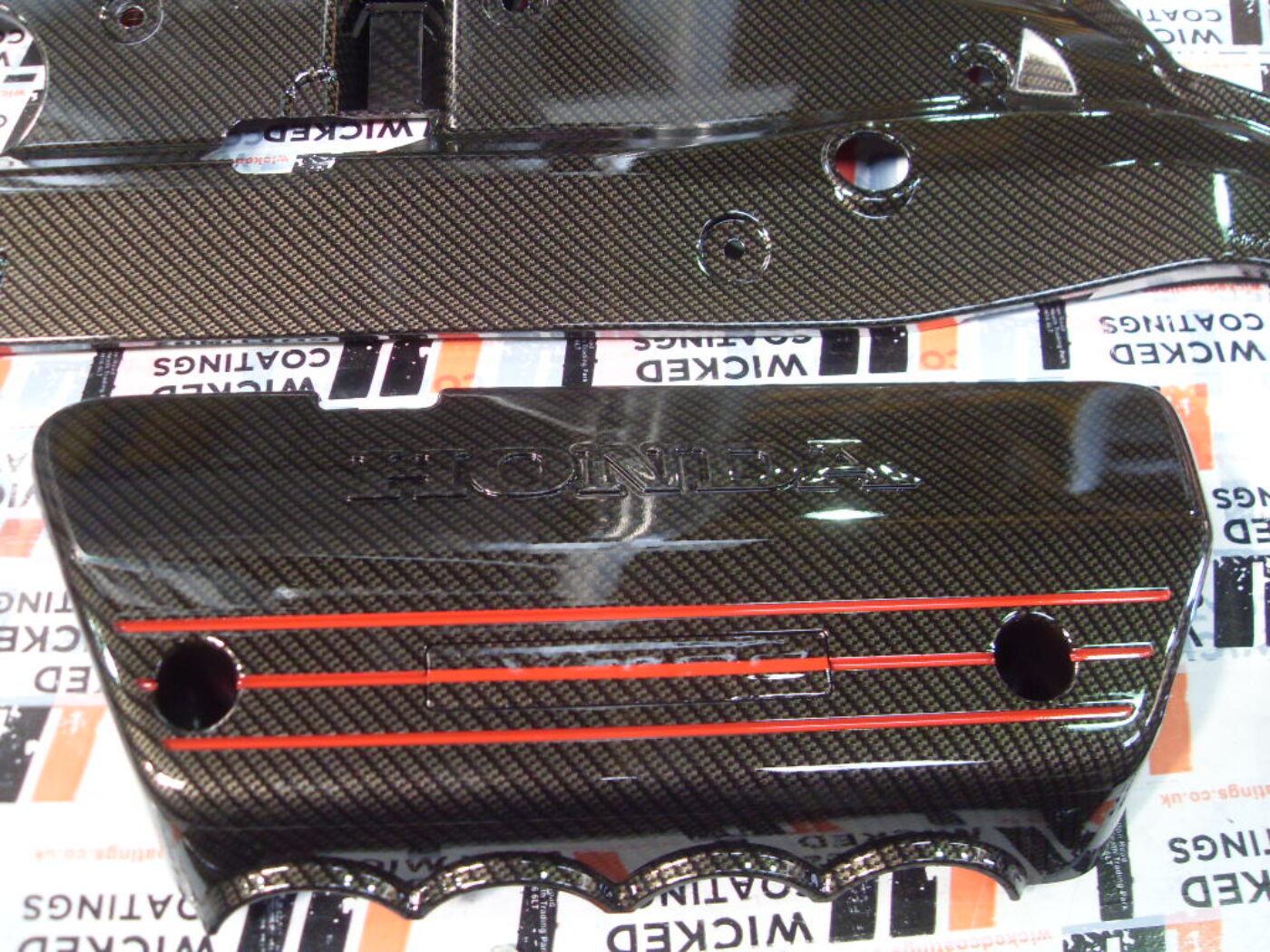 Honda engine parts coated in carbon fibre hydrographic film painted black