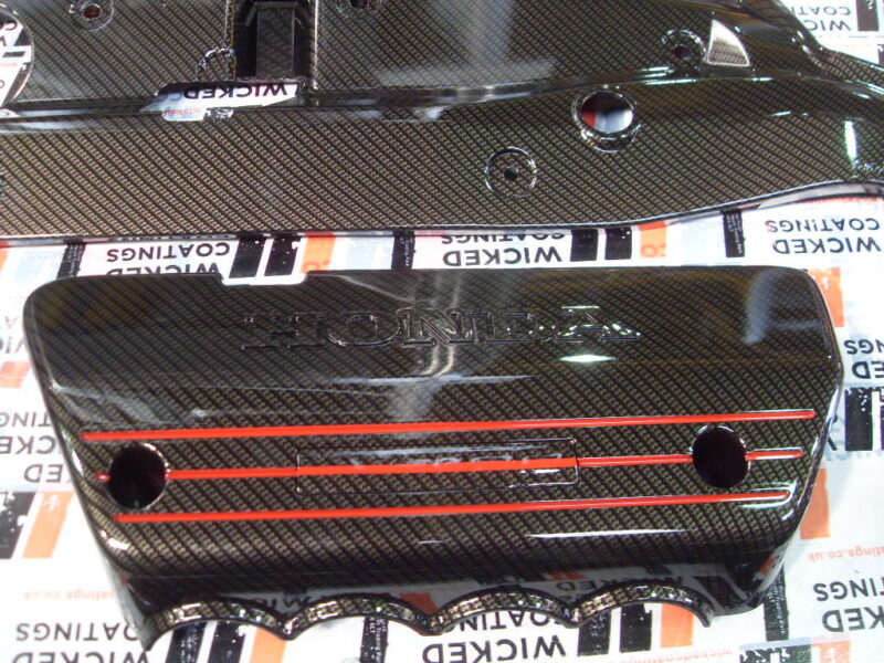 Honda engine parts coated in carbon fibre hydrographic film painted black