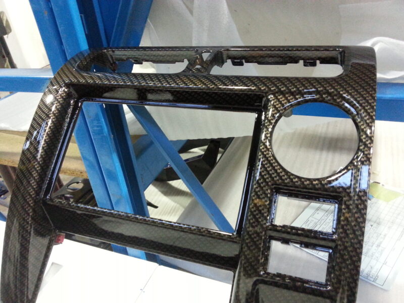 Car dashboard parts coated in carbon fibre hydrographic film painted black