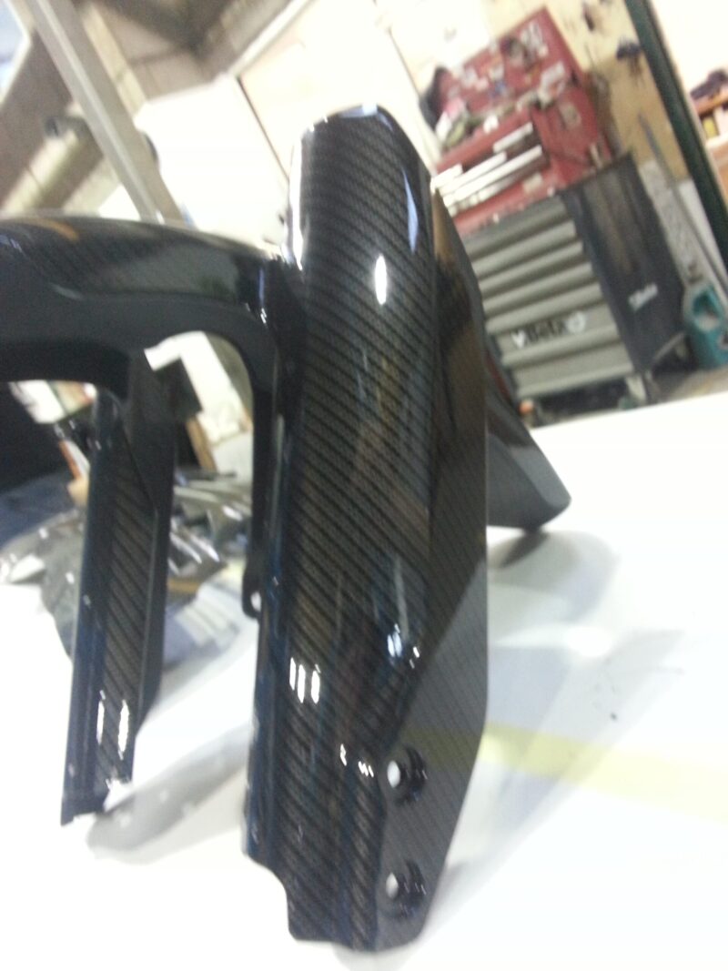 Motorbike element coated in carbon fibre hydrographic film painted black