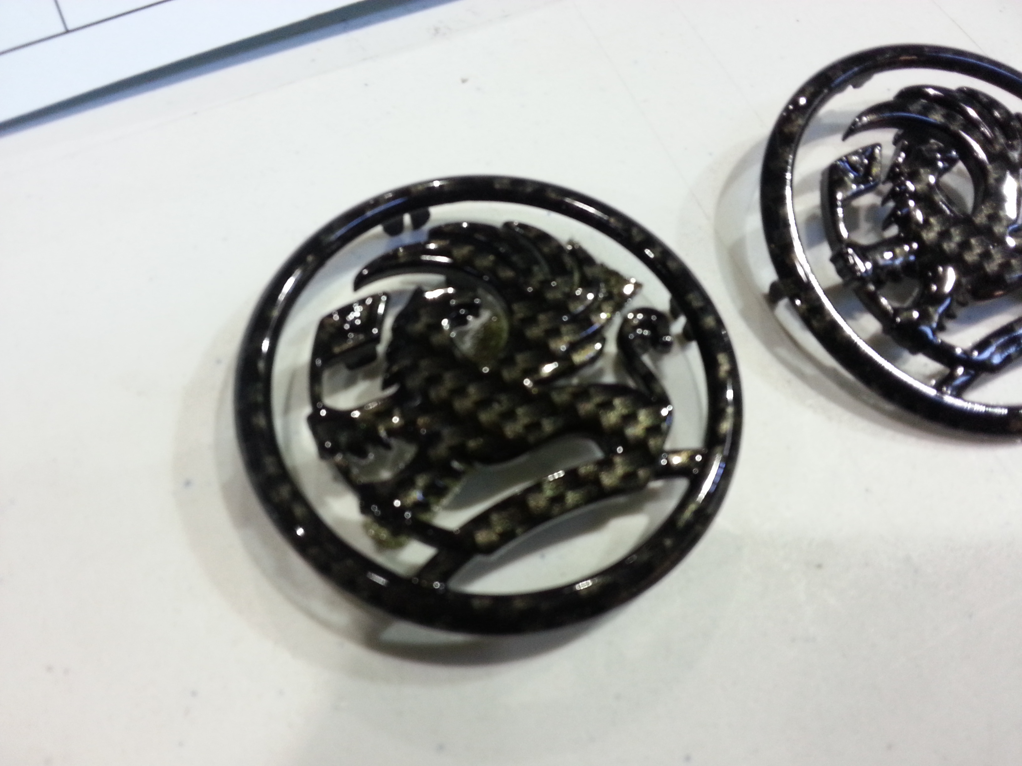 Vauxhall car badge coated in carbon fibre hydrographic film painted black