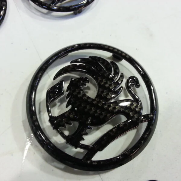 Vauxhall car badge coated in carbon fibre hydrographic film painted black