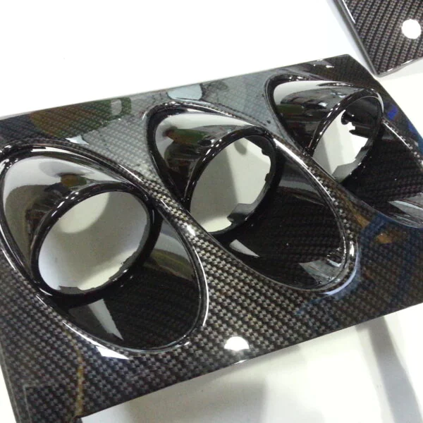 Car dashboard elements coated in carbon fibre hydrographic film painted black