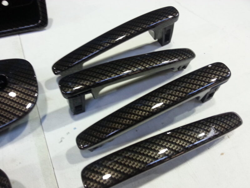 Car interior various elements coated in carbon fibre hydrographic film painted black