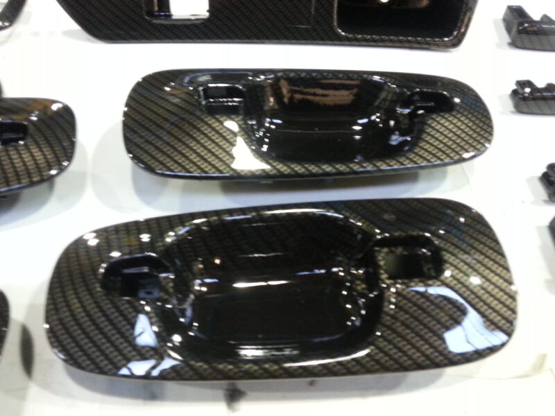 Car interior various elements coated in carbon fibre hydrographic film painted black